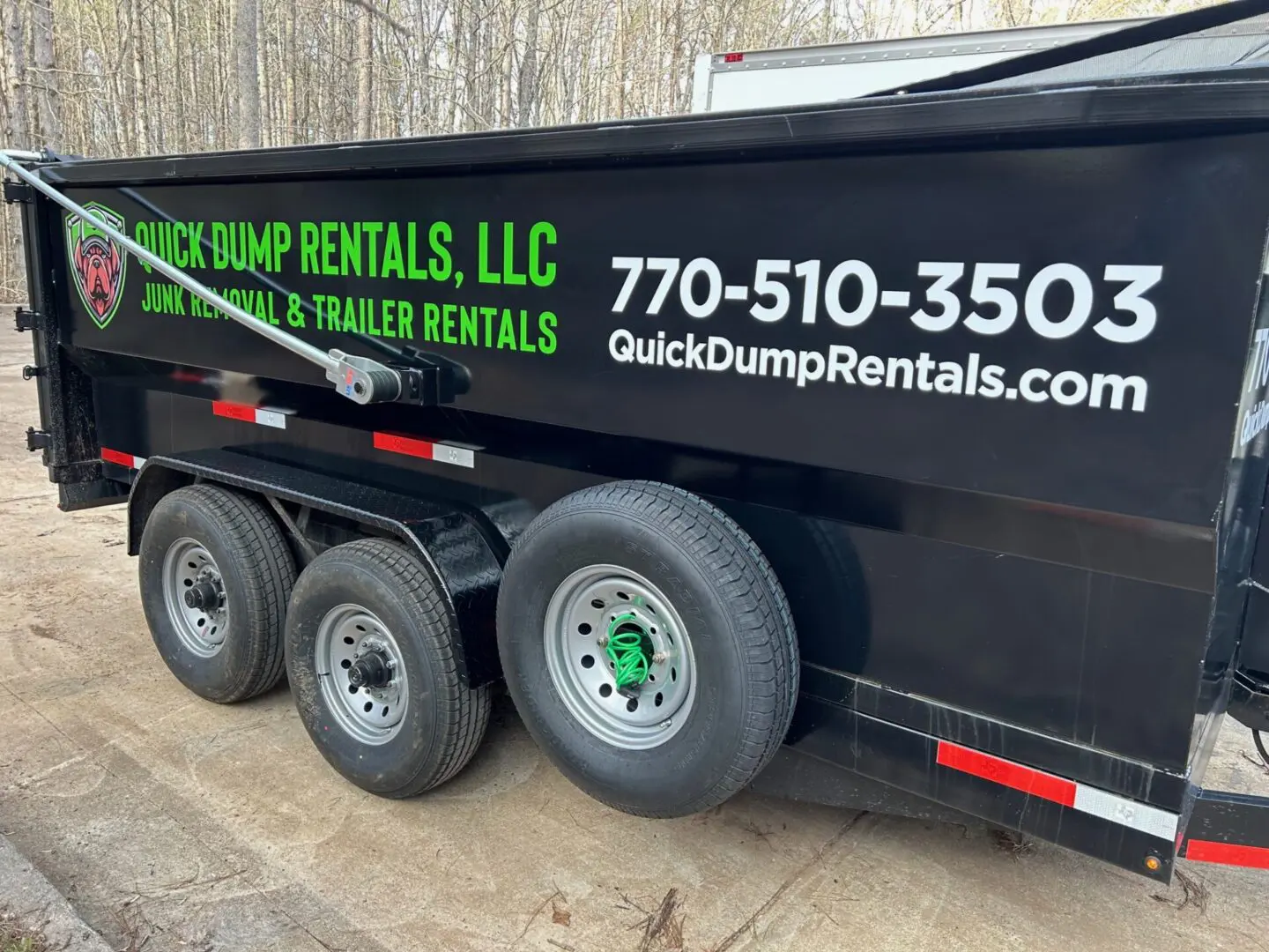 A dump truck with the words " quick dump rentals, llc." on it.